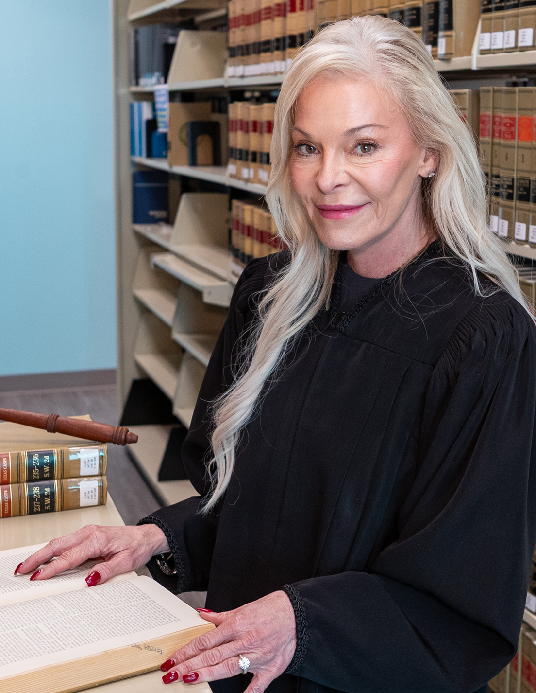 Judge Deeanne Galvan working with case files behind her